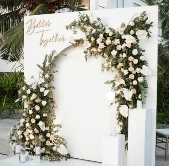White arched board with 'Better Together' script and white roses